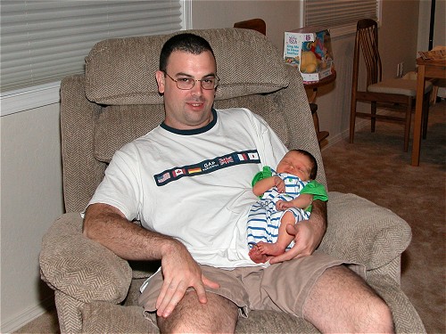 Little Aiden sleeping in his daddys arms
